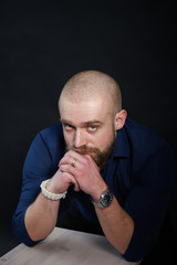a mysterious portrait of a man with a beard on a black background with a small amount of light