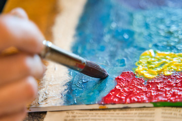 Older woman painting at home for entertainment