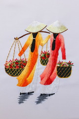 embroidery with a smooth surface. two women in national Vietnamese costumes with baskets of flowers 