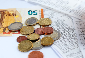 Euro bills coins receipts from the store. saving counting costs