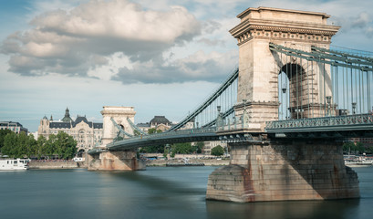 Naklejka premium Budapest Chain Bridge, opened in 1849, long exposure, clouds in the sky, Hungary 2019
