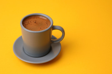 Turkish coffee placed on a yellow background