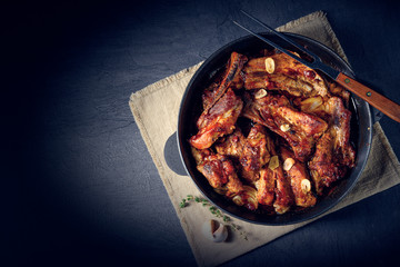 Spicy pork ribs with garlic and barbecue sauce - obrazy, fototapety, plakaty