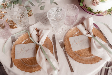 the table of the bride and groom is beautifully set in pink shades