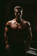 Obraz na płótnie Canvas silhouette of muscular man in gym