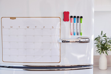 Erasable monthly planning calendar on refrigerator