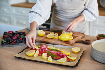 Woman at home making salmon for dinner
