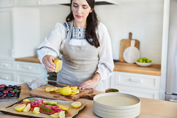 Woman making dinner in her kitchen at home