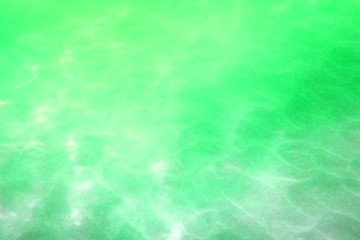The water in the swimming pool is green.Background. Details of water. Toned