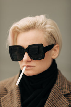 Portrait Of Young Blond Androgyne Woman With Big Sunglasses