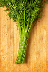 bunch of dill on a wooden board