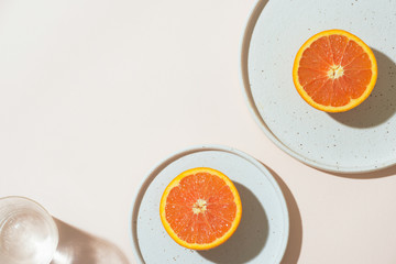 A Glass Of Water And Half Of Orange Fruit