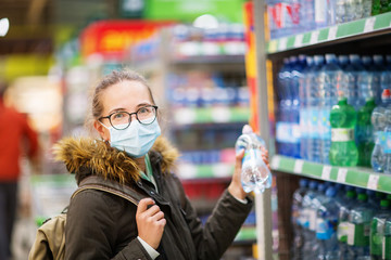 Caucasian woman shopping wearing mask