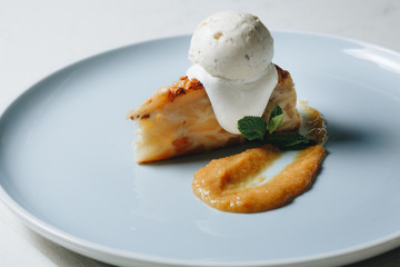 dessert pie with ice cream on a blue plate