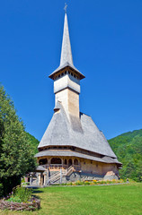Fototapeta na wymiar Church of Barsana Monastery, Maramures, Romania. The Barsana Monastery church is one of the tallest wooden church in Romania.