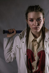 Young beautiful girl with a broken heart and a bat.