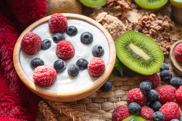 Greek yogurt in bowl with spoons,Healthy breakfast with Fresh greek yogurt, muesli and berries on background