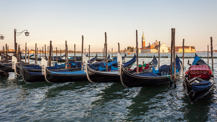 Gondolas moored by Saint Mark square with San Giorgio di Maggiore church, Venice