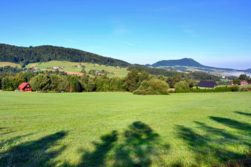 Obraz premium Beautiful summer landscape in the mountains with green meadows and forested hills, Low Beskids (Beskid Niski), Poland 
