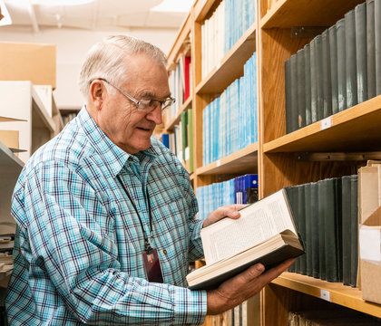 Librarian In The Stacks At College Museum Library