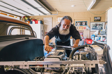 Senior Man Tinkering with his car