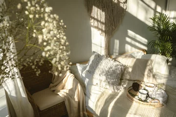 Fotobehang Boho Cozy boho style sunny bedroom with light and shadows and close up of white gypsophila flowers. Authentic real life interior  © Aleksandra Konoplya