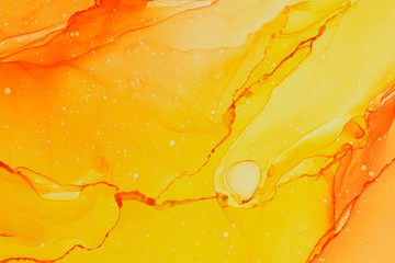 Abstract alcohol ink design in orange and yellow