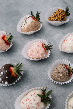 Strawberries covered with chocolate on a gray background