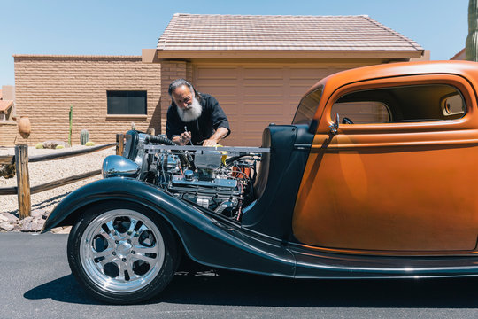 Retired Senior Man With his Orange Antique Car