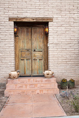 old double rustic door with pots on step