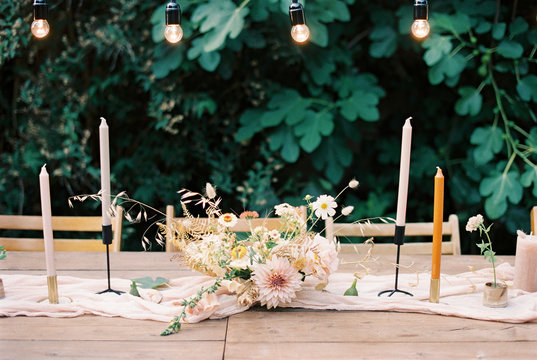 Styled Outdoor Wedding Table With Pastel Flowers And Candles