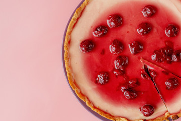 Plain cheesecake with cherry jelly on plate . Closeup view with copy space