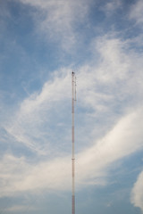 Obraz premium Telecommunication tower with blue sky and cloud