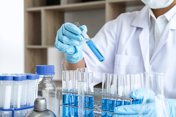 Scientist or medical in lab working in biotechnological laboratory using equipment for research with mixing reagents in glass flask in clinical laboratory