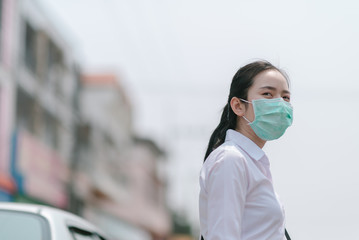 Asian women wear mask to protect COVID-19 dust and air pollution.