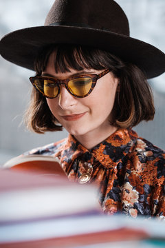 Stylish Brunette Woman Looking At The Books On The Street Market