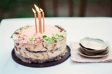 Festive cake decorated with flowers, on film