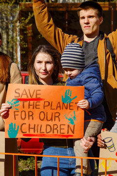Young family holding banner on demonstration