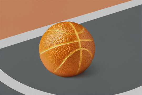 Basketball ball made from orange fruit on a brown gray field wit