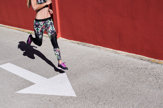 Crop sportswoman urban running sprint.