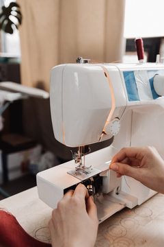 Woman working with patterns of paper.