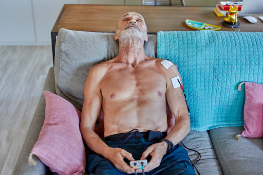 Senior athlete using muscle stimulator