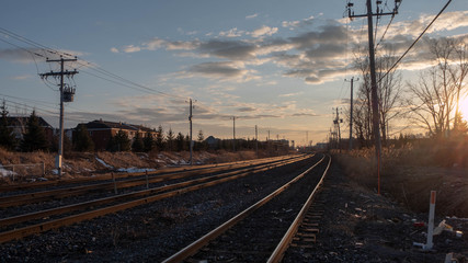 Fototapeta na wymiar Railroad tracks by the sunset