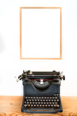 historical typewriter under a blank picture with space.
