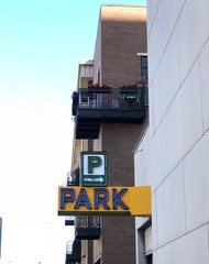 Directional Parking sign on the side of a building