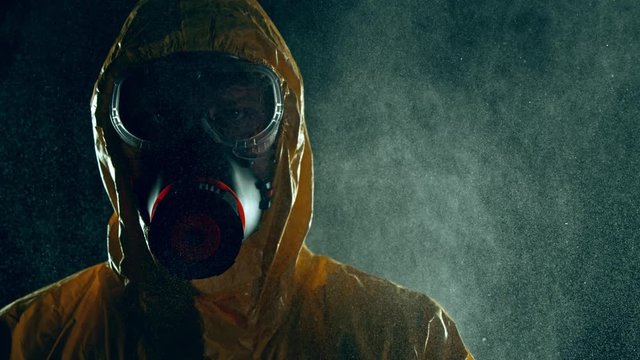 Super Slow Motion Shot of Man in Hazmat Suit and Blowing Aerosol at 1000 fps.