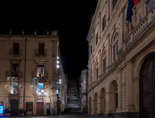 Fototapeta premium Empty street of the sicilian town Caltagirone at night and view of its famous stairs, province of Catania, Sicily
