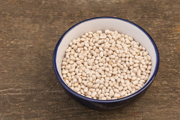 A plate of raw beans on wooden background, Beans benefits