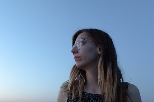 Portrait of a young woman at dusk