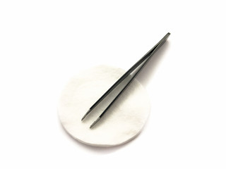 Tweezers and  cotton pad isolated on a white background. Professional tweezers for hair. Black tweezers for eyebrow. Set of tweezers and cotton pads. Cosmetic cotton pads.
